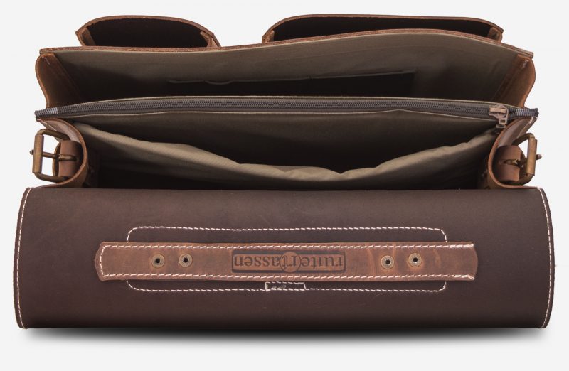 Inside view of large 2 compartments brown leather satchel with 2 front asymmetric pockets.