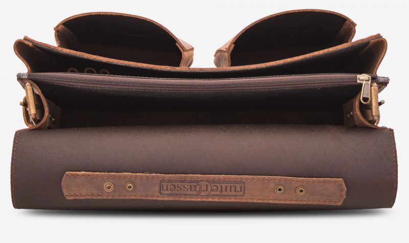 Inside view of the brown leather satchel with 2 main compartments and two front pockets.