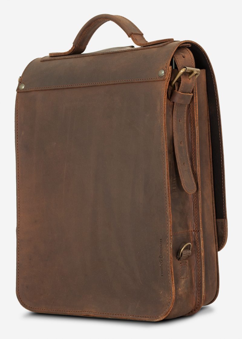 Back view of the vegetable-tanned brown leather backpack with shoulder belt.