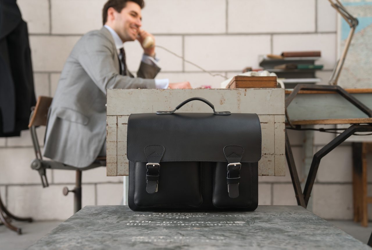 Man in office with large black leather briefcase with 3 compartments and asymmetric front pockets 112142.