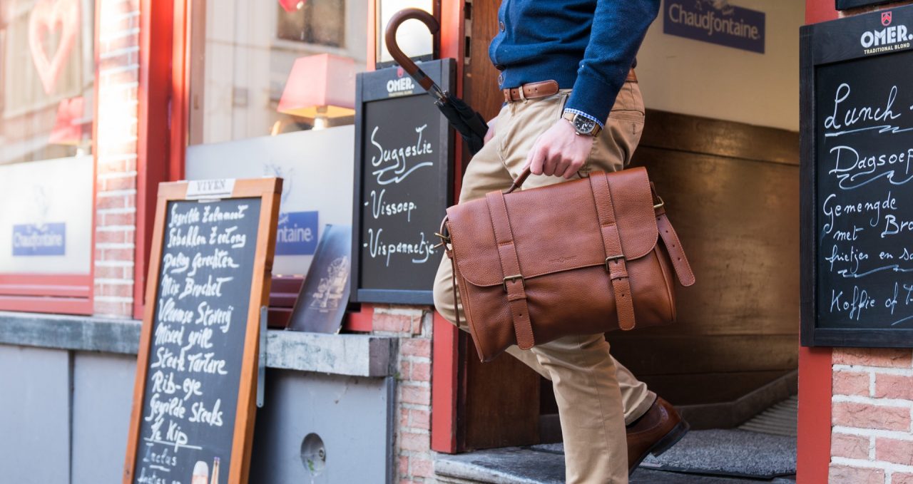 Man wearing the soft brown leather briefcase bag.
